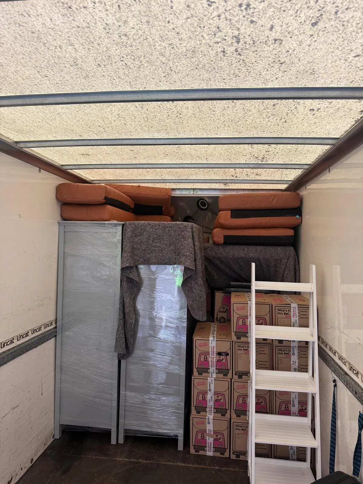 A removal van parked for loading on a residential street